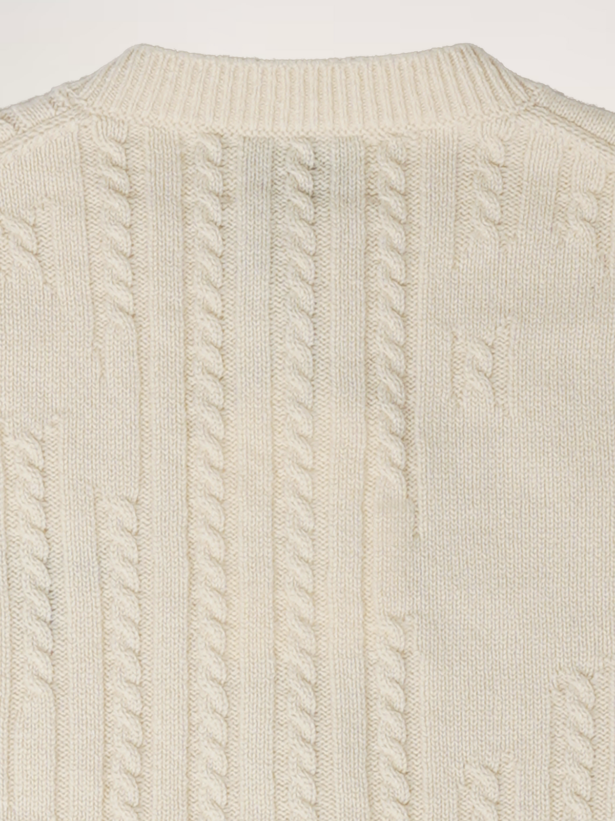 Close-up view of the TENDLER cream white recycled cashmere cardigan, highlighting the dissolving cable knit texture.